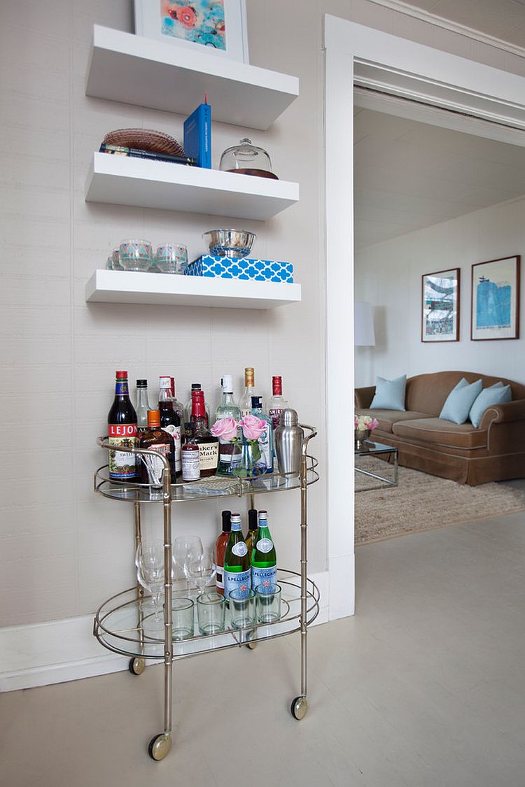 A vintage bar cart and a few floating shelves is all you need for a tiny home bar [Design: Maggie Stephens Interiors]