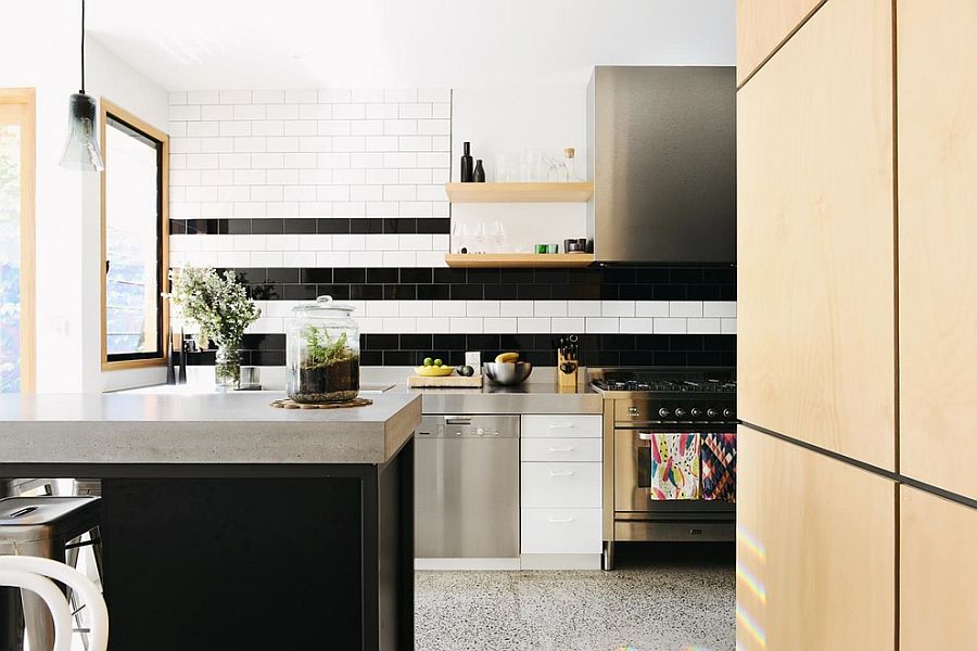 An innovative take on adding stripes to the kitchen backsplash with black and white tiles