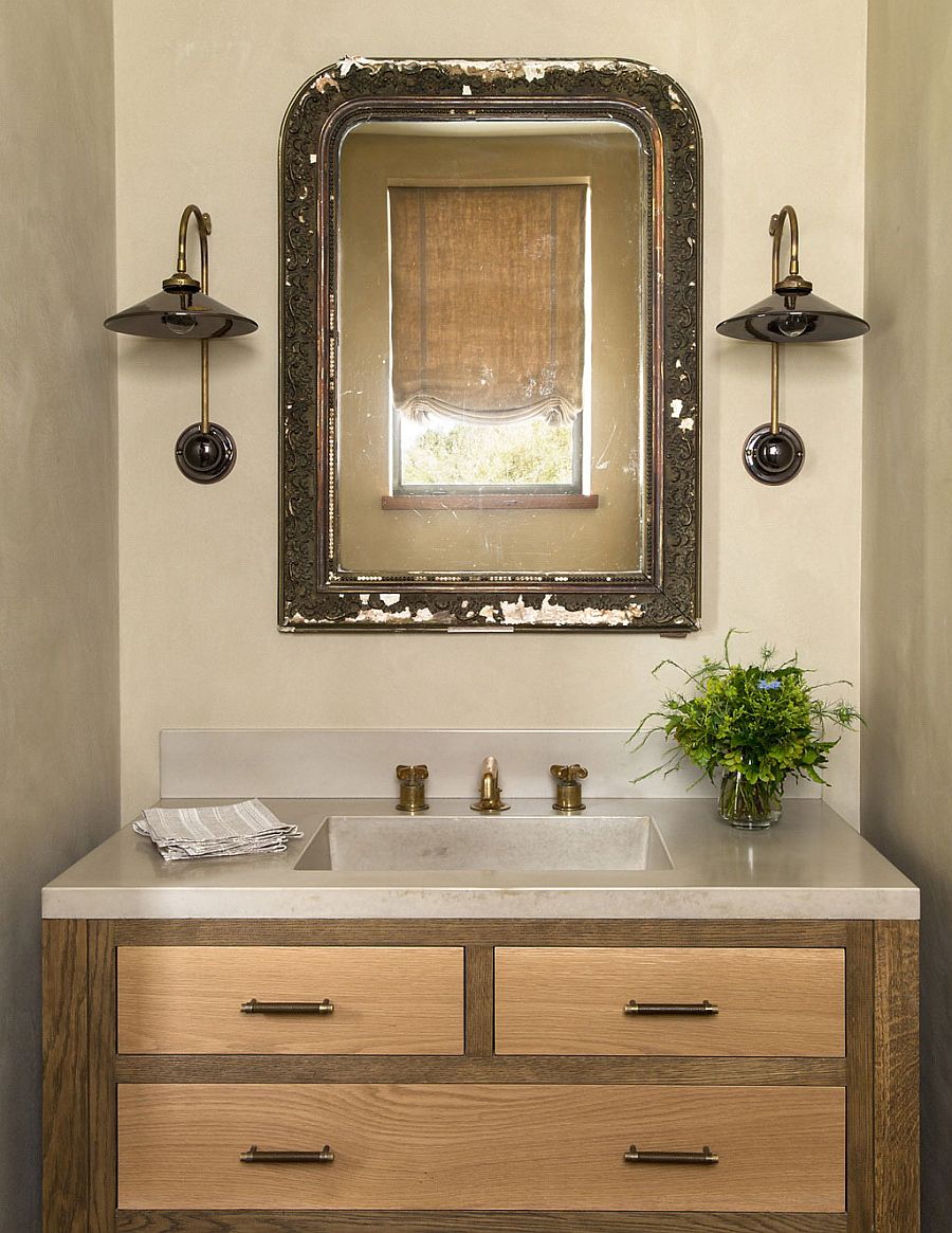 Antique English mirror and French sconces for the rustic powder room