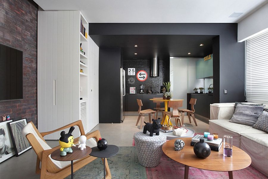 Black kitchen area demarcates space without using walls