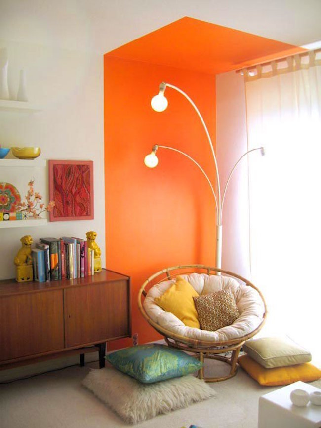 Bright orange reading nook that goes right up to the ceiling