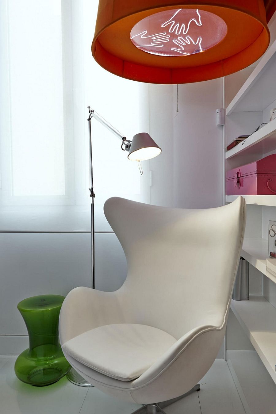 Bright red lighting above the Arne Jacobsen Egg Chair