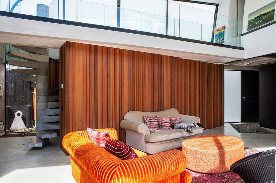 Cedar accent wall in the living room adds inviting warmth to the industrial design palette