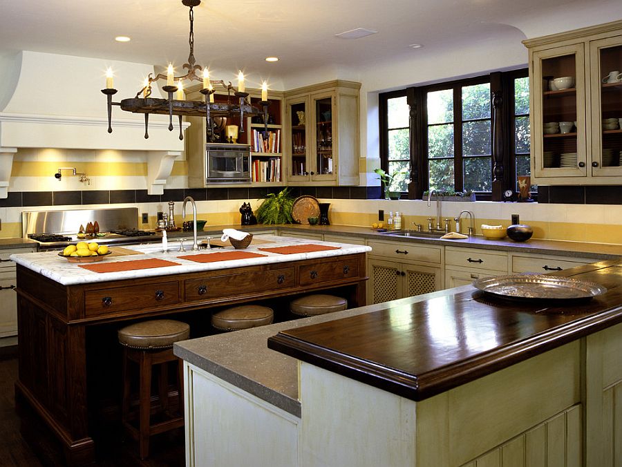 Classy Mediterranean kitchen with a striped backsplash [Design: Tommy Chambers Interiors]