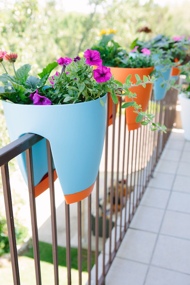 Colorful planters that sit on your balcony railing