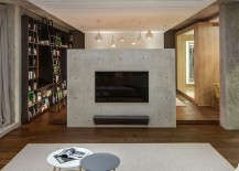 Concrete-fireplace-acts-as-a-divider-between-two-different-zones-217x155