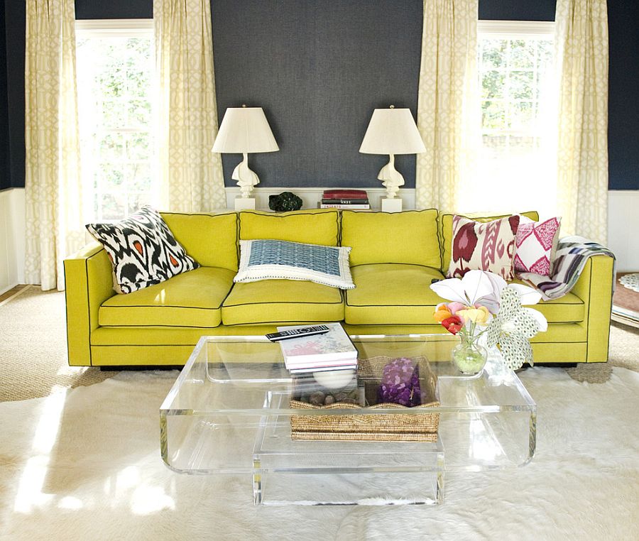 Cozy yellow couch and acrylic coffee table enliven the living space [From: Luck Stone Center]