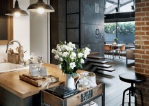 Custom-crafted-concrete-panels-brick-wall-and-lighting-add-industrial-charm-to-the-apartment-217x155