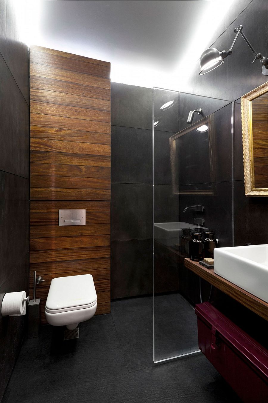Dark concrete panels give the bathroom a moody, elegant appeal