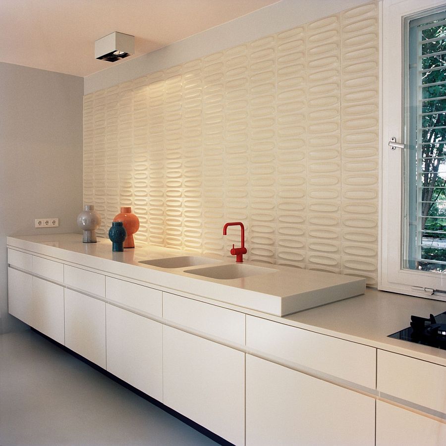 Decorative ceramic tiled backdrop in the contemporary kitchen in white