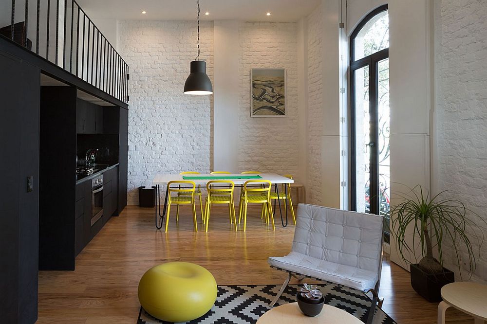 Dining table chairs in yellow and kitchen in black