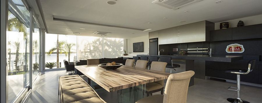 Dining table in natural wood adds textural contrats to the space