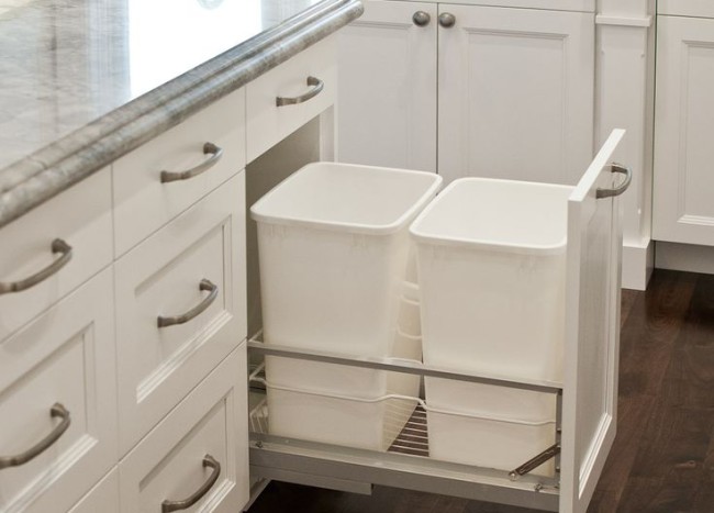 Double Garbage Cans Hidden In White Cabinetry 650x467 