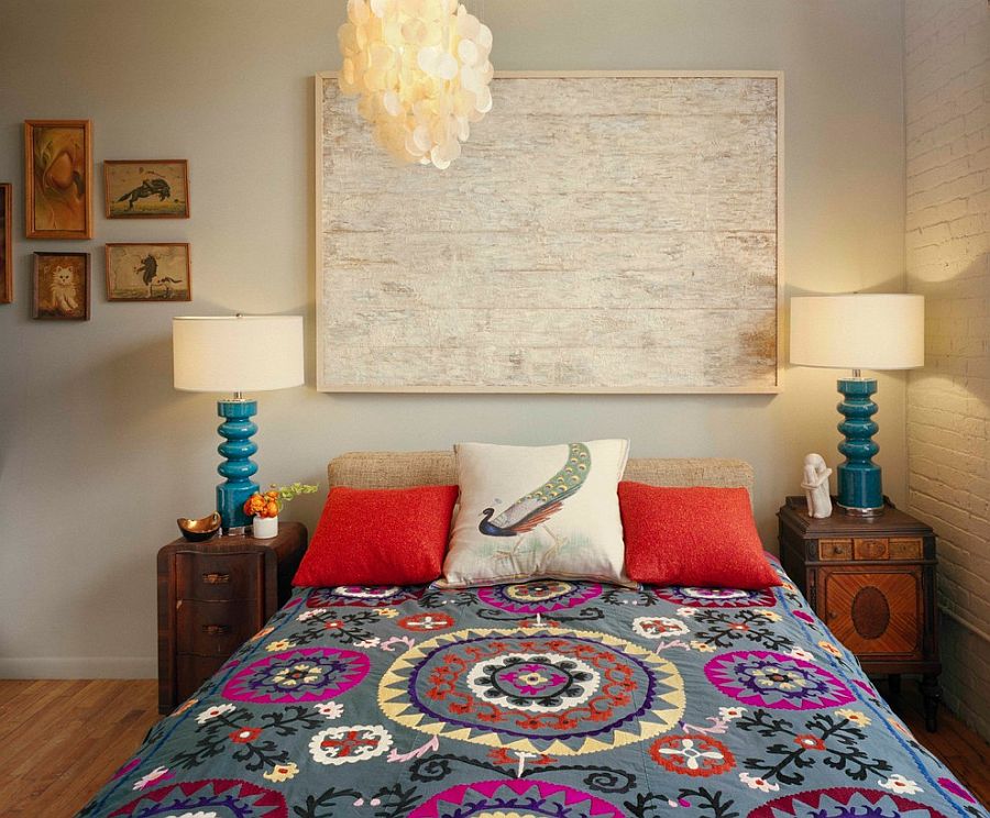 Eclectic bedroom with mismatched nightstands and twin bedside lamps