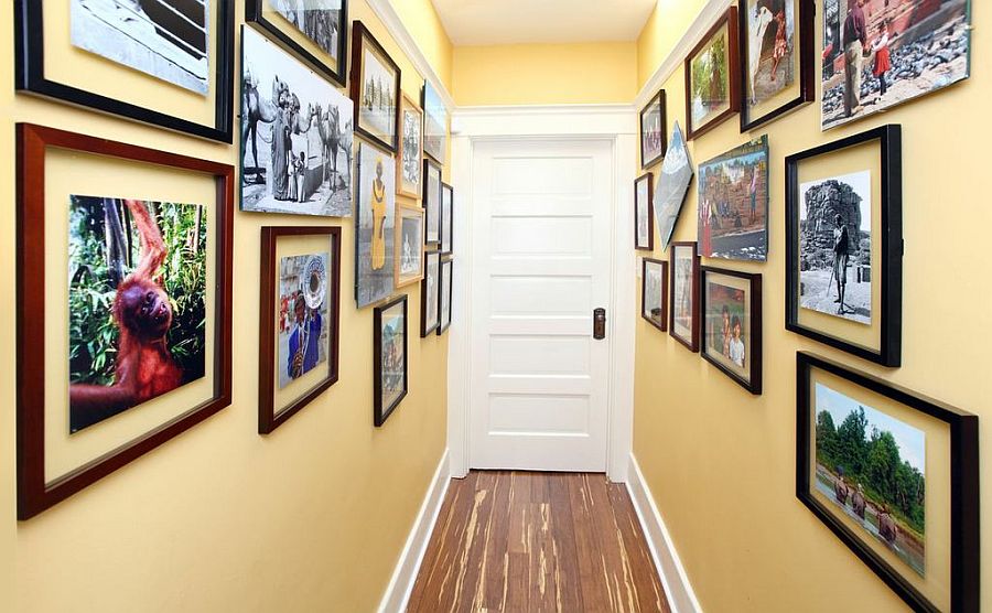 Gallery walls create a beautiful  entry with initing warmth and color