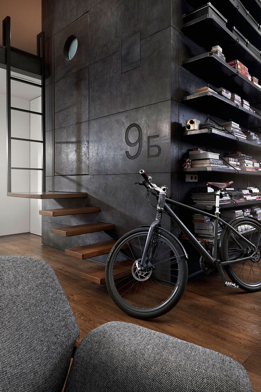 Giant dark cube in the living room made from custom dark concrete panels