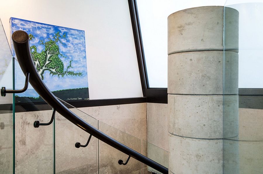 Glass and steel railing for the concrete spiral staircase