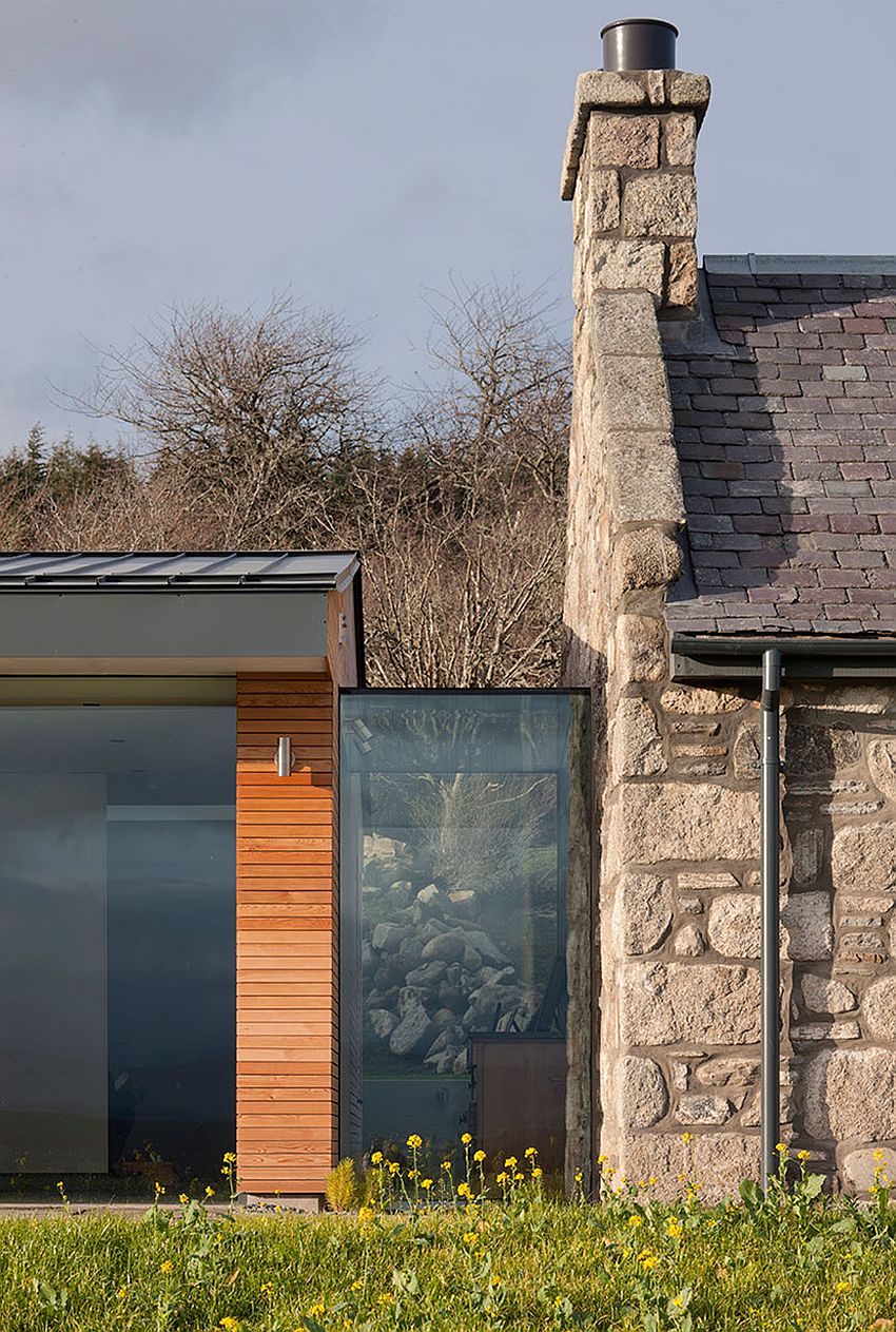 Glass and timber modern structure meets lovely cottage in stone
