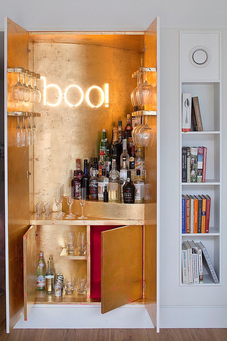 Gold leaf sheets and illuminated sign for the wardrobe home bar [Design: MATT Architecture]