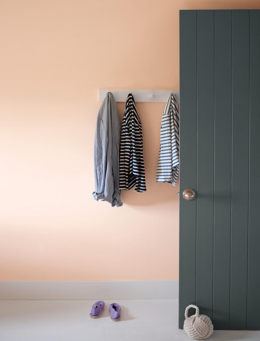 Hanging wall hooks in a peach entryway