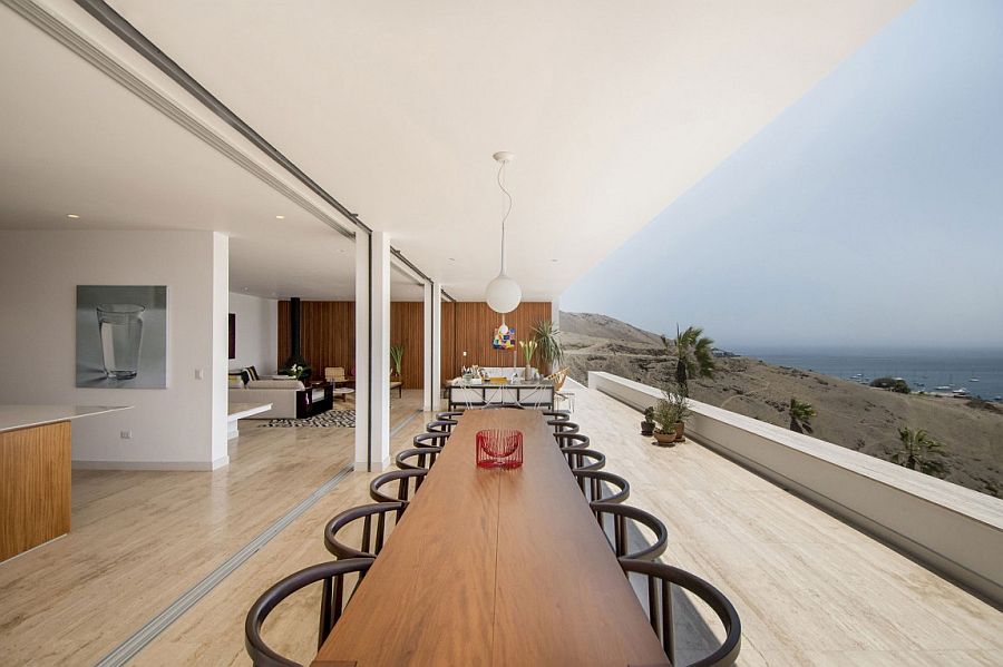 Large outdoor dining space and hangout connected with the living area visually and overlooking the Pacific