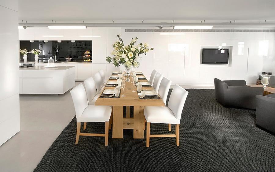 Large textured black rug in a dining and living area