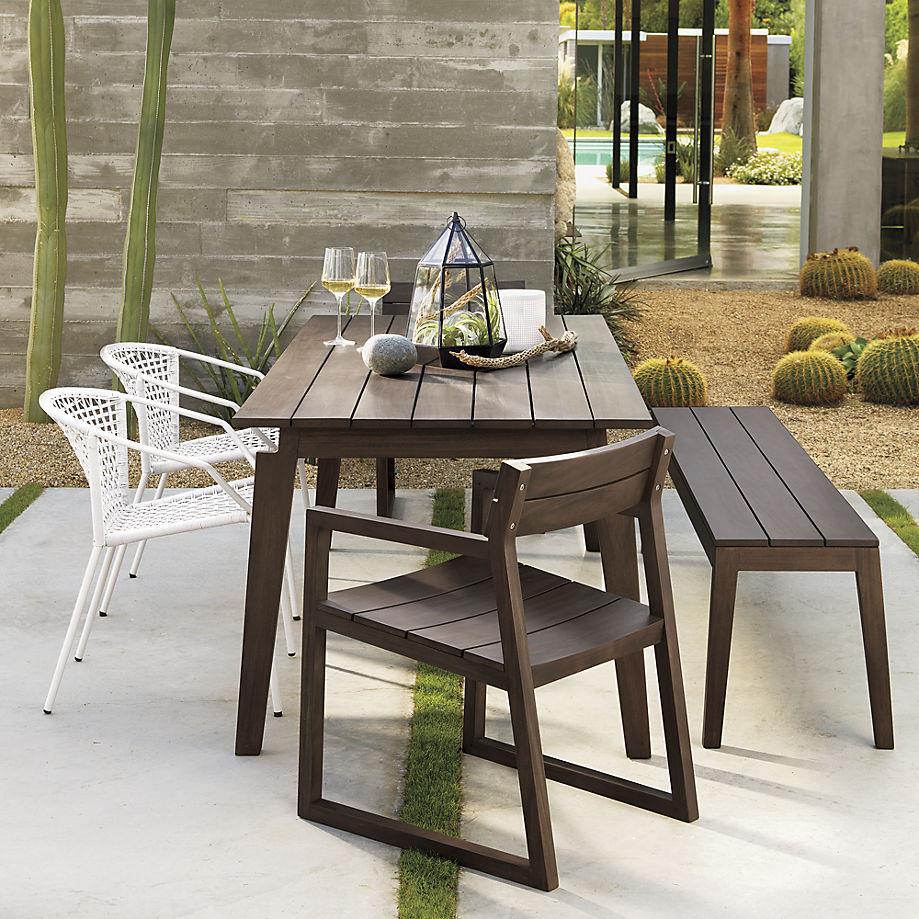 Light silver dining chairs paired with slatted furnishings