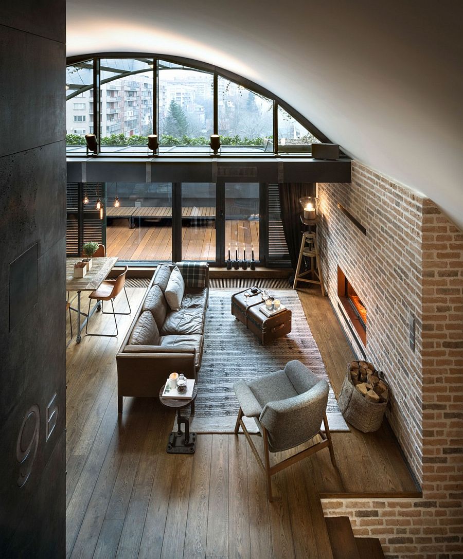 Living area of the attic apartment with brick walls and vintage decor