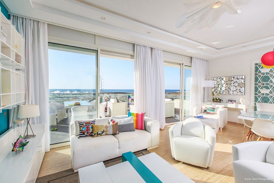 Living room in white with pops of brilliant color and ocean view