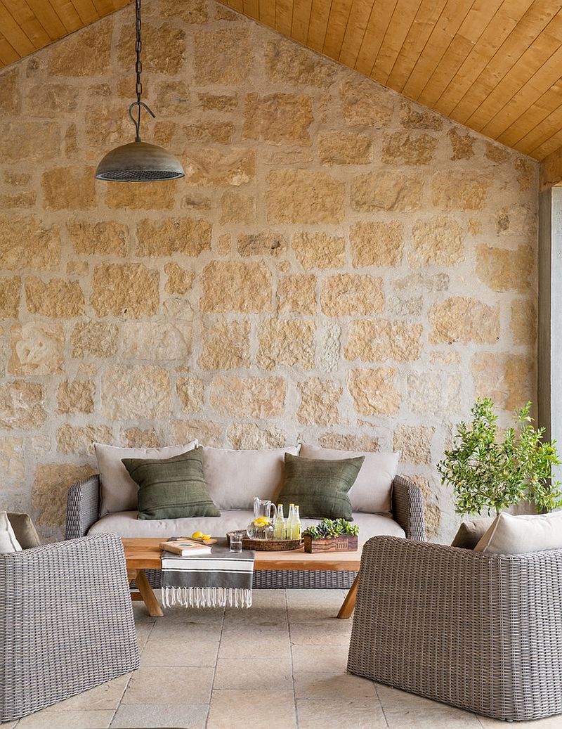 Lovely patio with stone wall and cozy decor