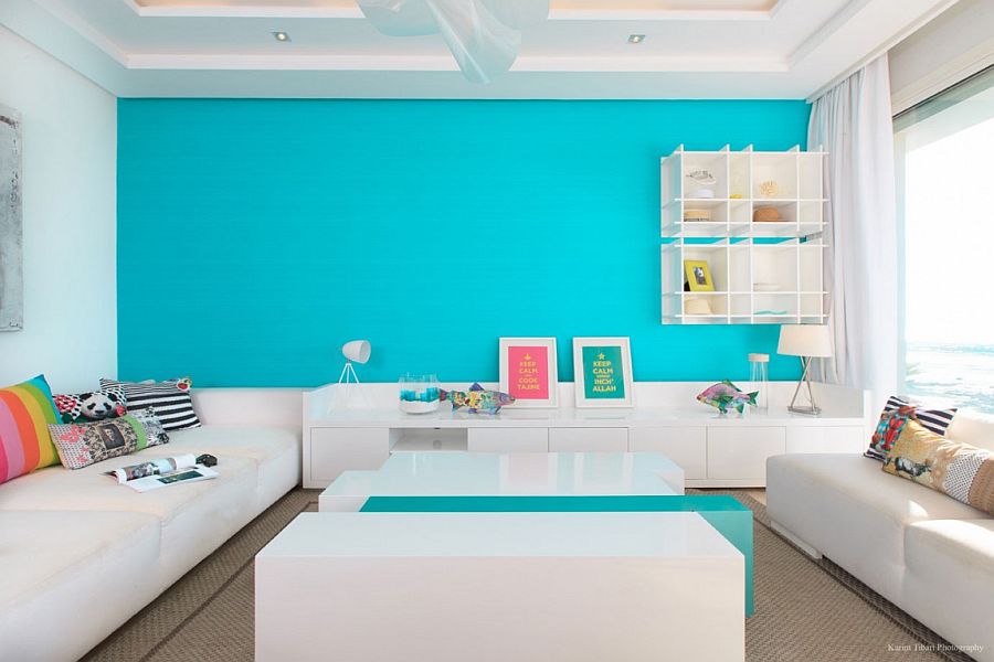 Lovely splash of turquoise in the living room creates a vivacious accent wall