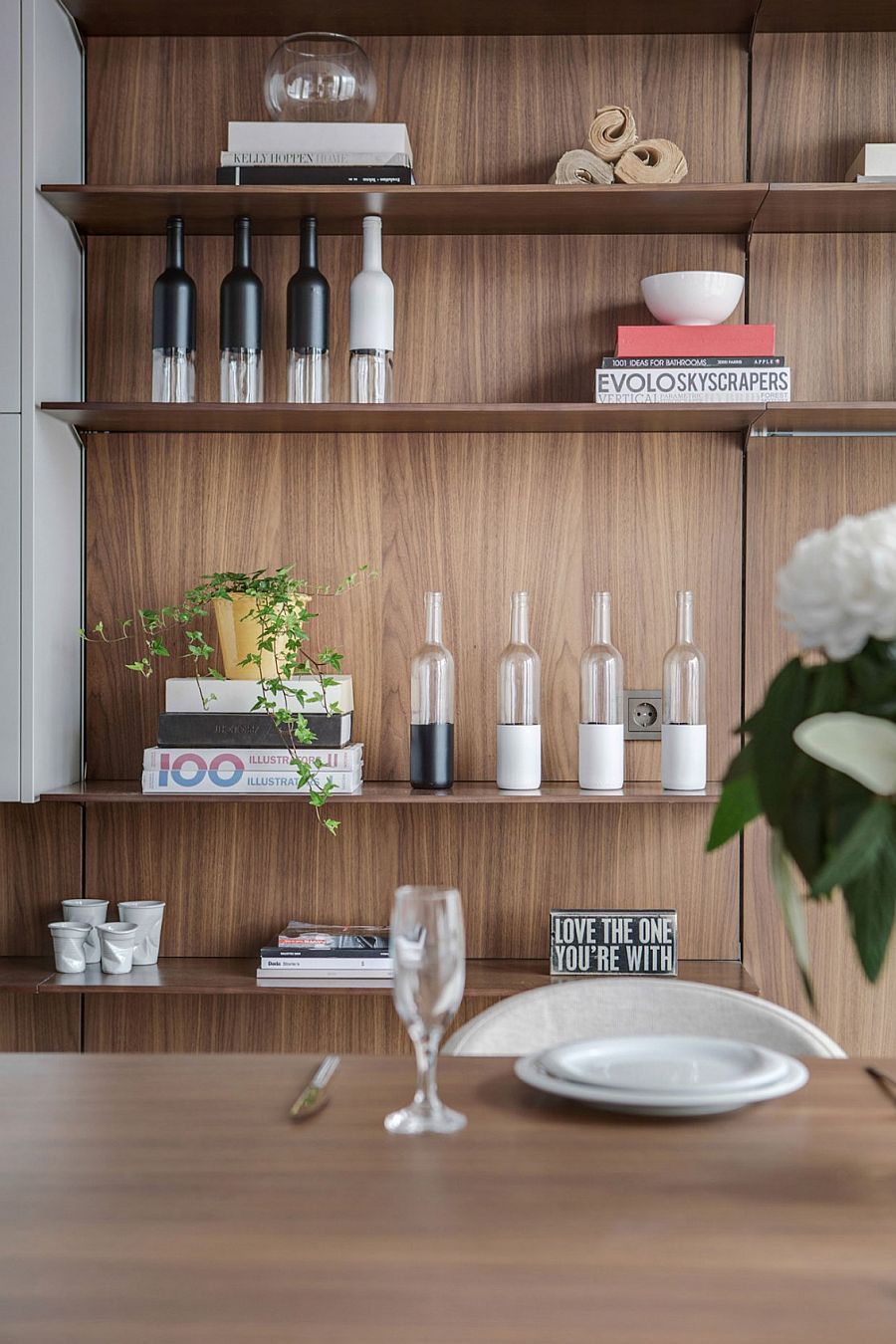 Open floating shelves in the kitchen coupled with minimal white cabinets