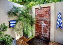 Outdoor-shower-with-palm-fronds-and-striped-towels-217x155