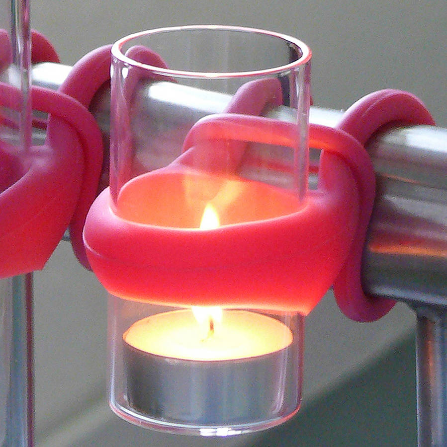 Pink holder to hang tea light candles on a balcony