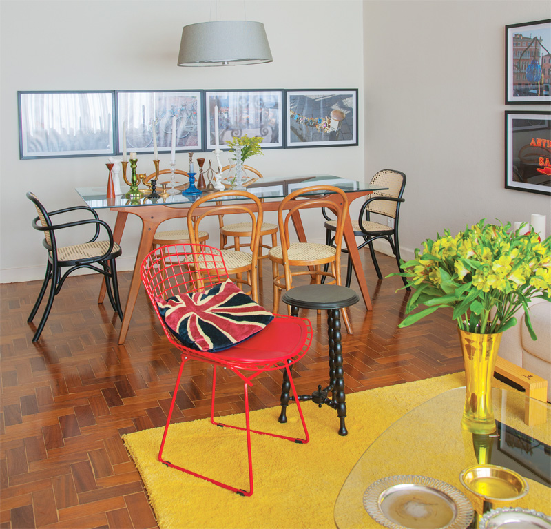 Plain, bright yellow rug separates living room from dining room