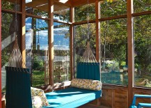Porch-swing-offers-a-comfy-seating-option-in-the-sunroom-217x155