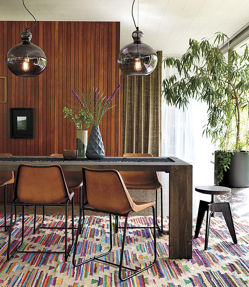 Potted plants and vase greenery add life to this modern dining room