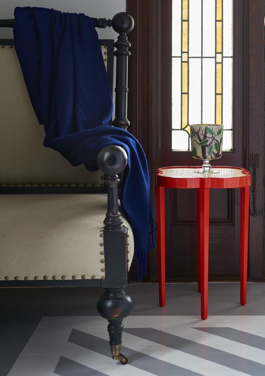 Red quatrefoil table in an entryway