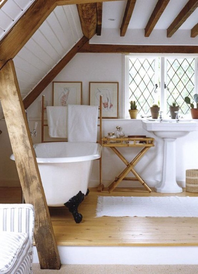 Rustic attic bathroom with wooden beams