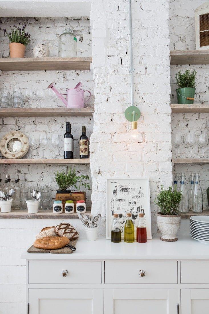 Rustic eclectic kitchen with a white brick wall