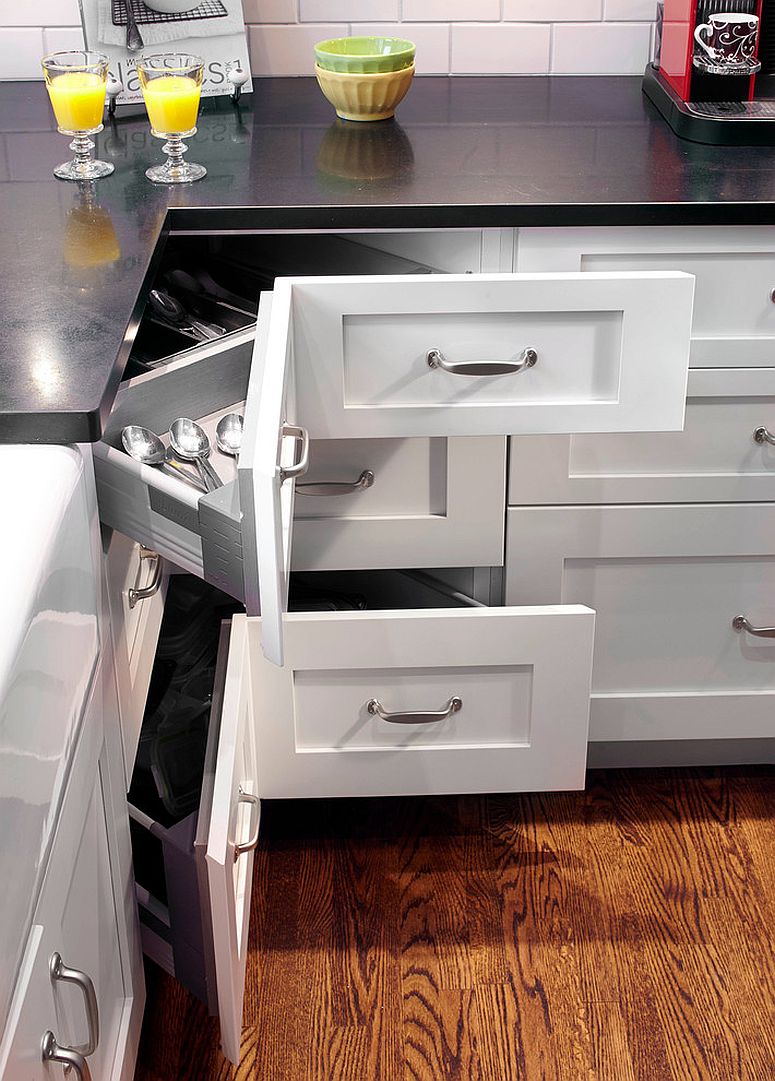 Shaker style kitchen with an L-shaped layout maximizes storage space with corner pullout drawers