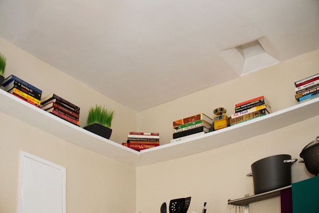 Shelves that surround the top of the kitchen ceiling