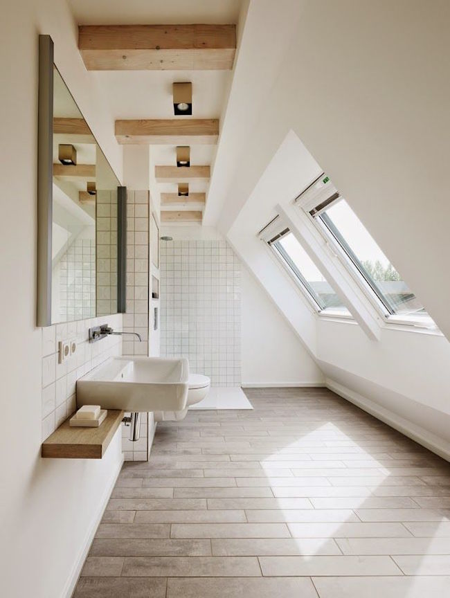 Simple bathroom designed to highlight attic shape and architecture
