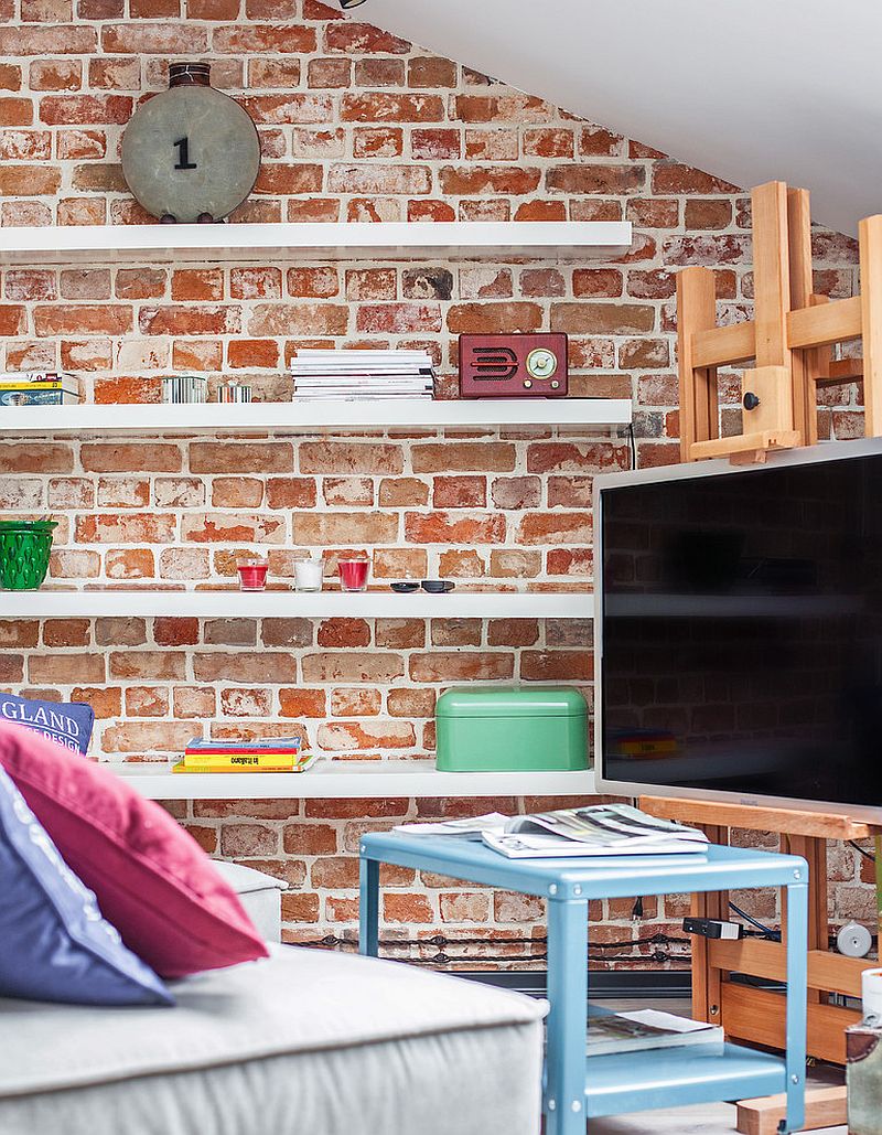 Sleek floating shelves and TV stand for the tiny living room with brick walls