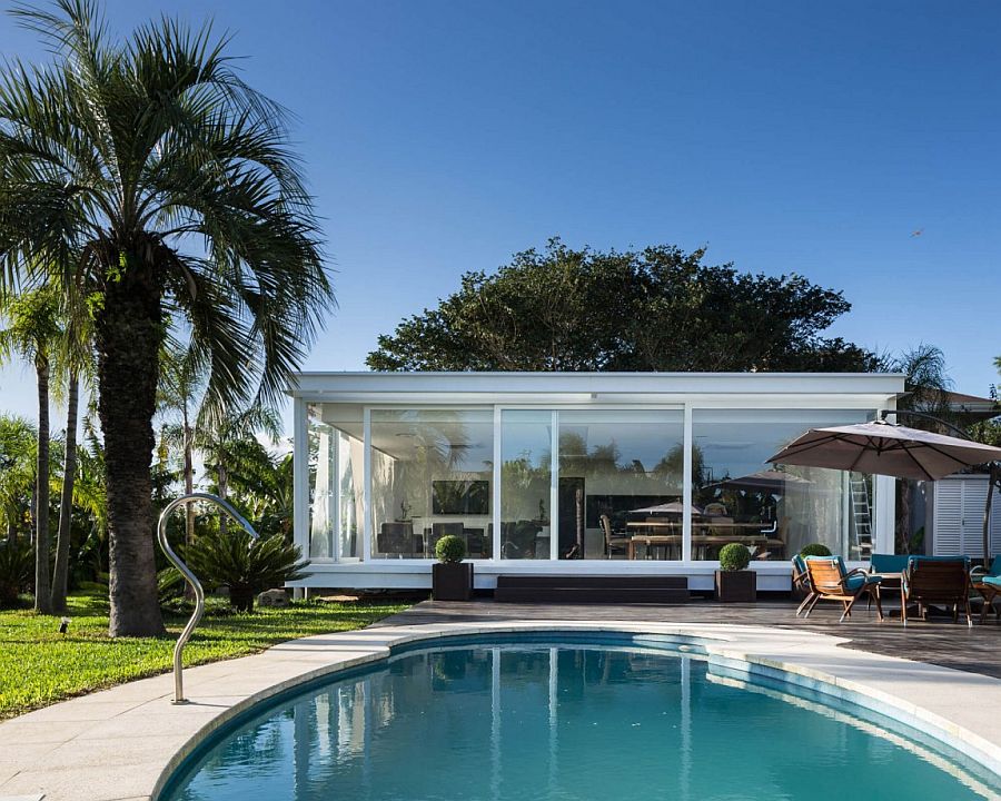 Sliding glass walls of the Pool House bring the outdoors inside