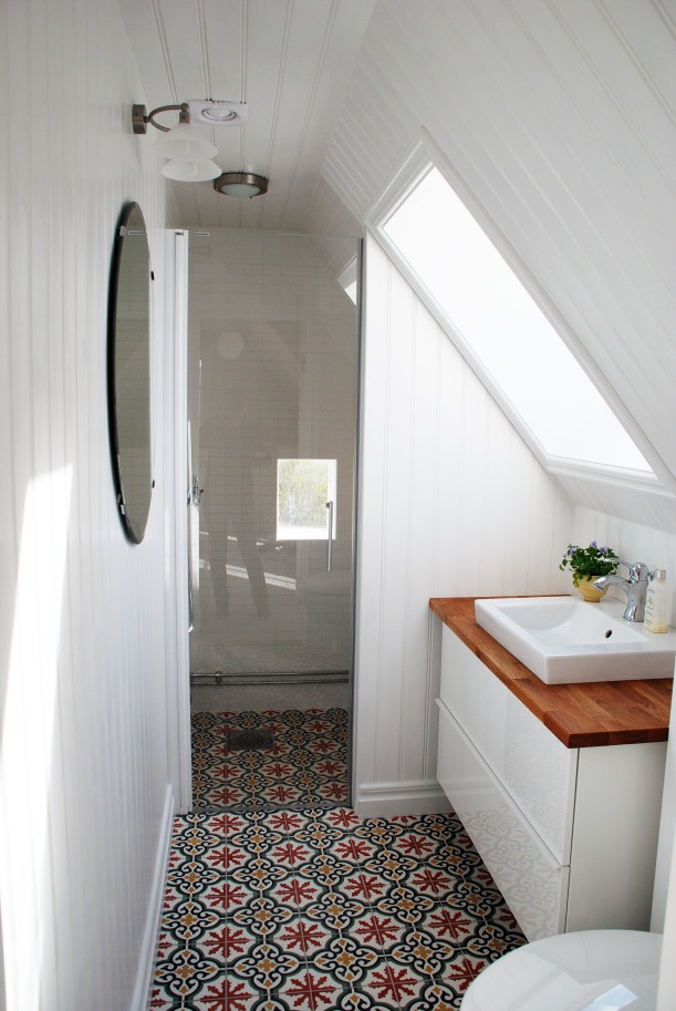 Small attic bathroom with Moroccan floor tiles