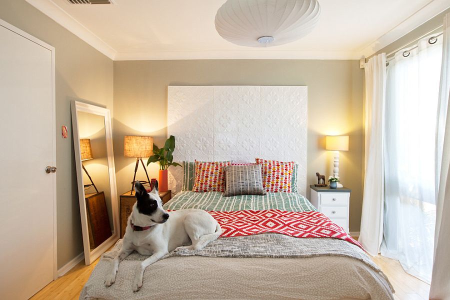 Small bedroom decorating idea with mismatched bedside tables and a mirror [From: Red Images Fine Photography]