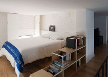 Small-bedroom-with-white-brick-walls-and-organized-shelf-217x155