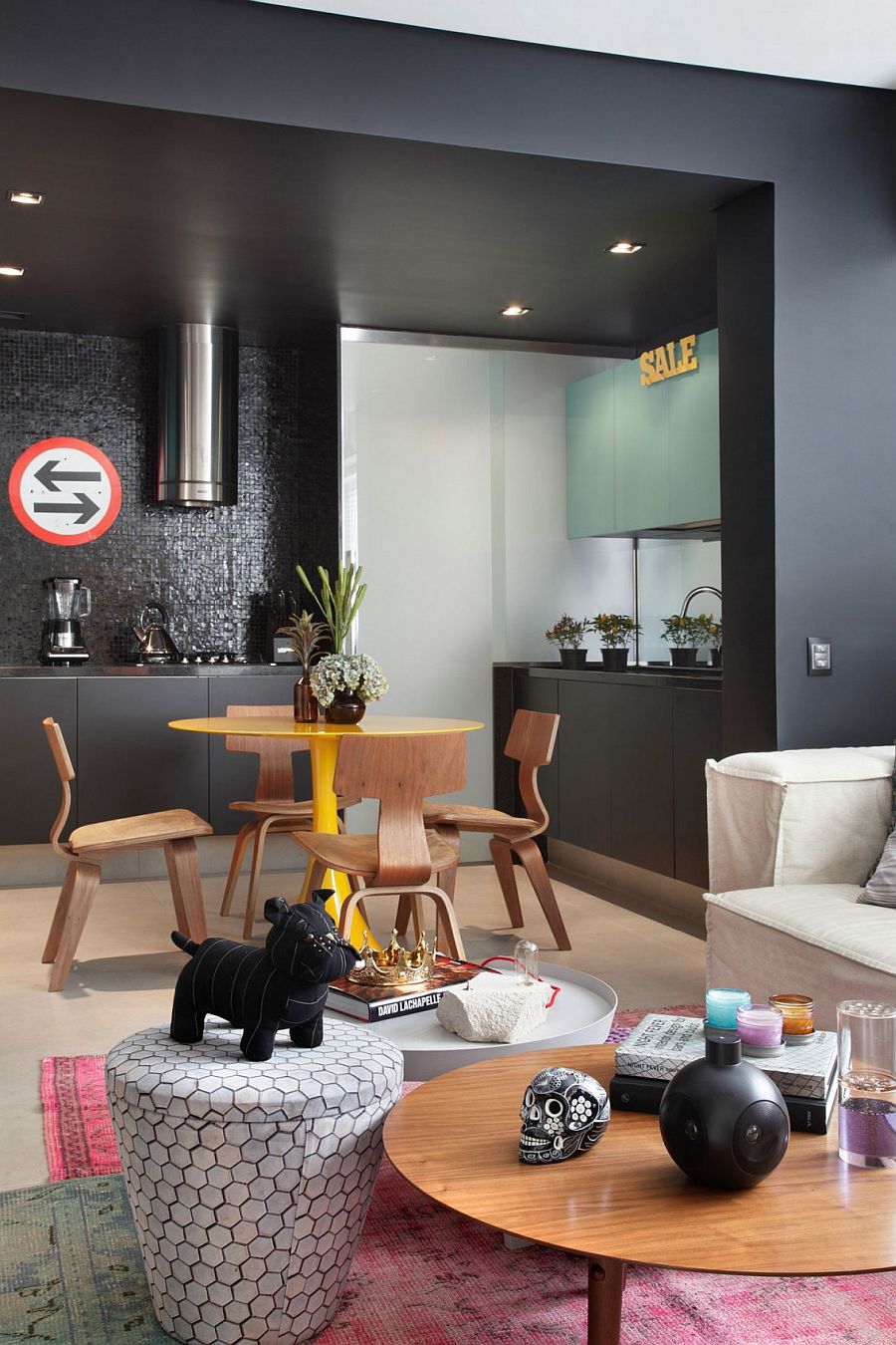 Small dining space in the kitchen with a pedastal dining table in bright yellow