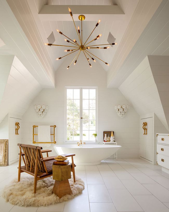 Spacious and bright attic bathroom with soaking tub